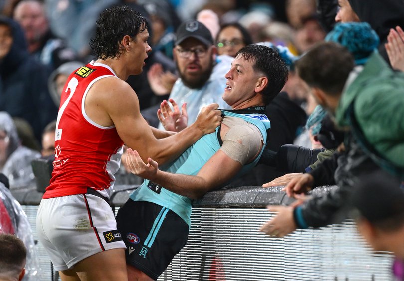 Zak Butters tangles with Marcus Windhager on Sunday night.