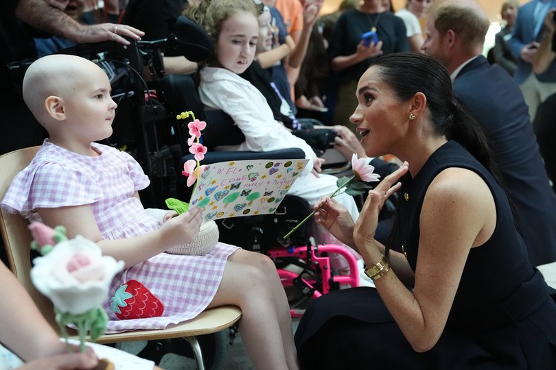 Meghan, Duchess of Sussex receives flowers and a card from a young patient on a visit to the Royal Children's Hospital with her husband Prince Harry, Duke of Sussex on April 14, 2026 in Melbourne.