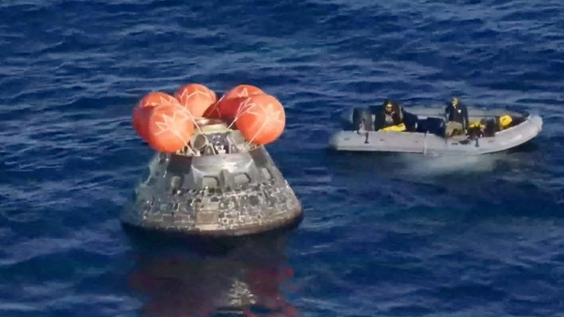 NASA shows a boat approaching the Artemis II crew capsule after it splashed down.