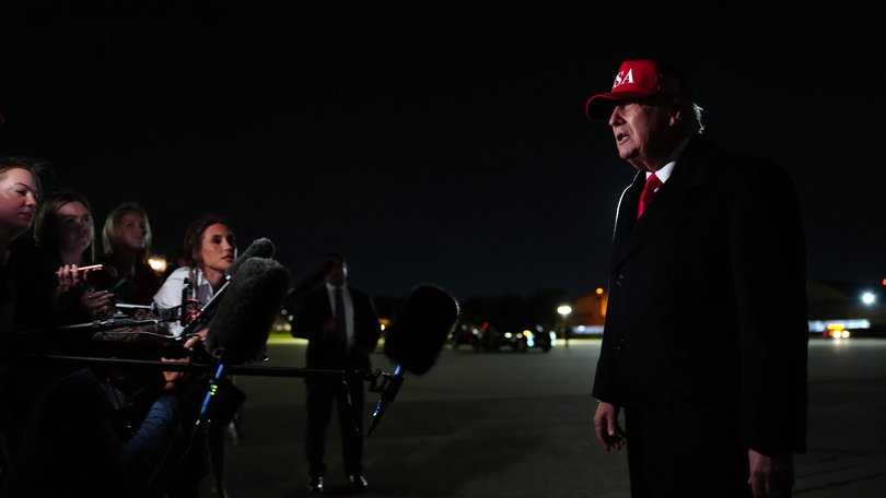 President Donald Trump speaks to reporters on Sunday night.