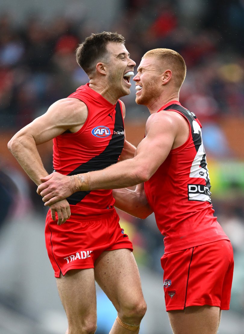 Peter Wright and Zach Merrett celebrate.