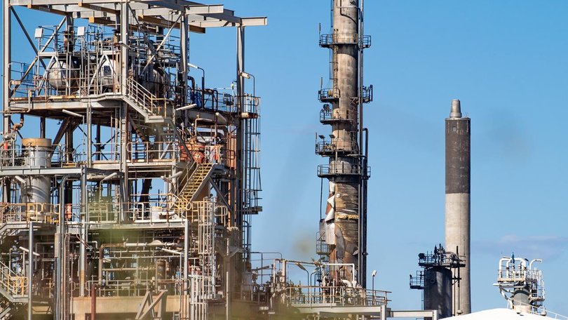 The fire is tamed at one of Australia's two oil refineries and its cause if being investigated. 