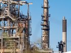The fire is tamed at one of Australia's two oil refineries and its cause if being investigated. 