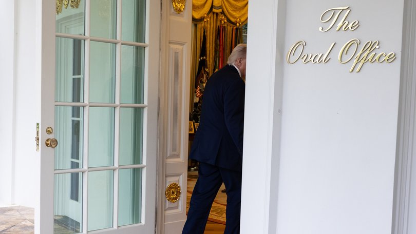 President Donald Trump returns to the Oval Office after speaking to reporters.