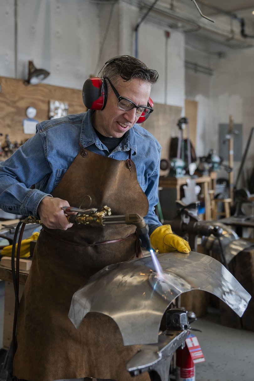 Jeffrey Wasson works on a breastplate at WassonArtistry, his appointment-only shop in Ridgewood, Queens.