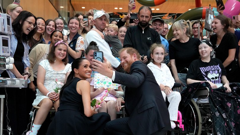 Meghan and Prince Harry pose for a selfie with children and their families during a visit to the Royal Children's Hospital on April 14, 2026 in Melbourne.