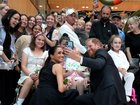 Meghan and Prince Harry pose for a selfie with children and their families during a visit to the Royal Children's Hospital on April 14, 2026 in Melbourne.