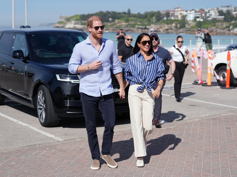 Prince Harry and Meghan Markle arrive at Bondi Beach.