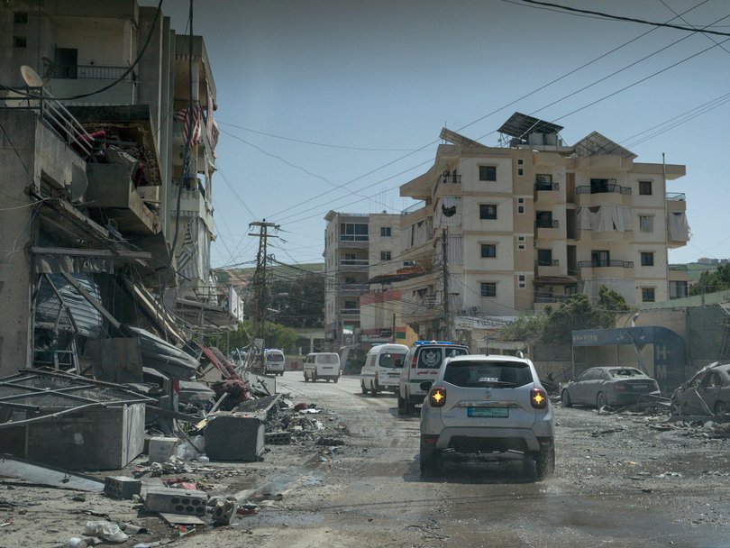 A convoy of ambulances is seen during the funeral of a paramedic killed in an Israeli air strike the day before the ceasefire began.