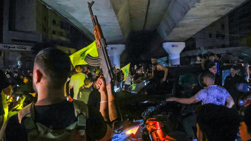 Hezbollah supporters in Beirut celebrate ceasefire with Israel as it takes effect.