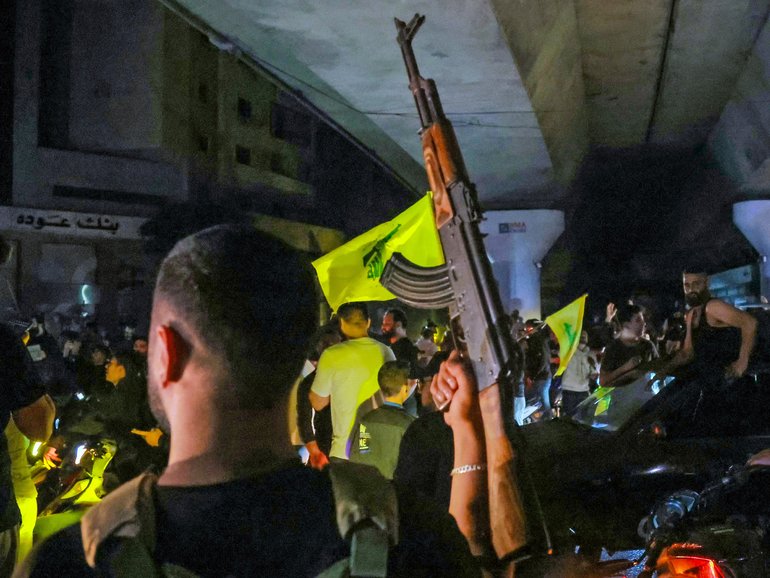 Hezbollah supporters in Beirut celebrate ceasefire with Israel as it takes effect.