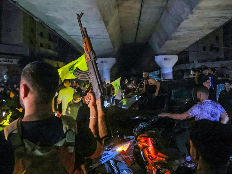 Hezbollah supporters in Beirut celebrate ceasefire with Israel as it takes effect.