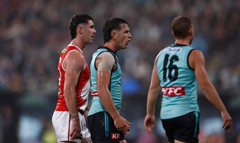 Zak Butters (left) and Ollie Wines of the Power (right) are seen after a 50 metre penalty