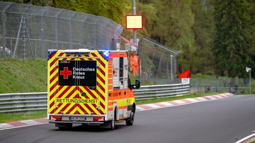 An ambulance leaves the track following a crash at the Nordschleife.