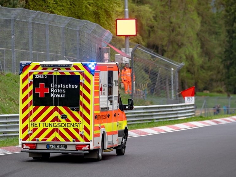 An ambulance leaves the track following a crash at the Nordschleife.