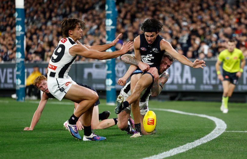 Elijah Hollands is tackled by Tim Membrey.