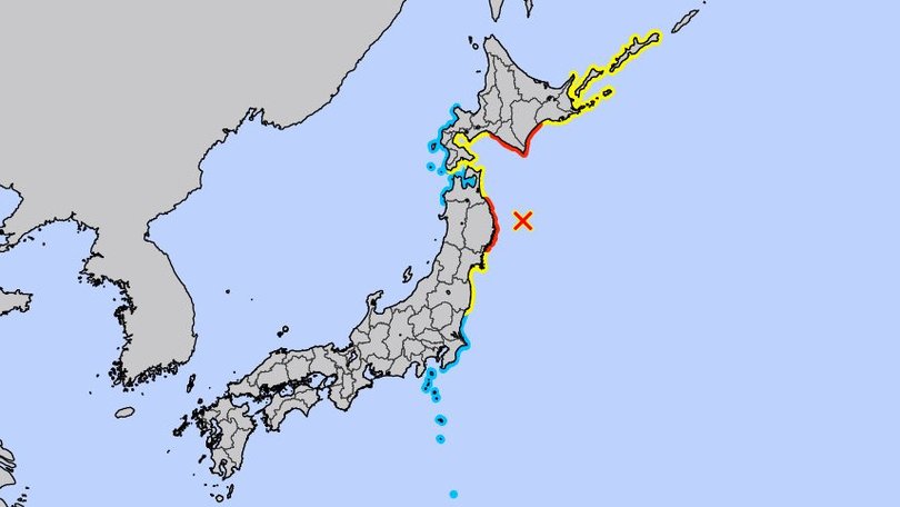A map of Japan with red representing areas at high risk of the incoming tsunami while yellow is advisory.