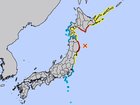 A map of Japan with red representing areas at high risk of the incoming tsunami while yellow is advisory.