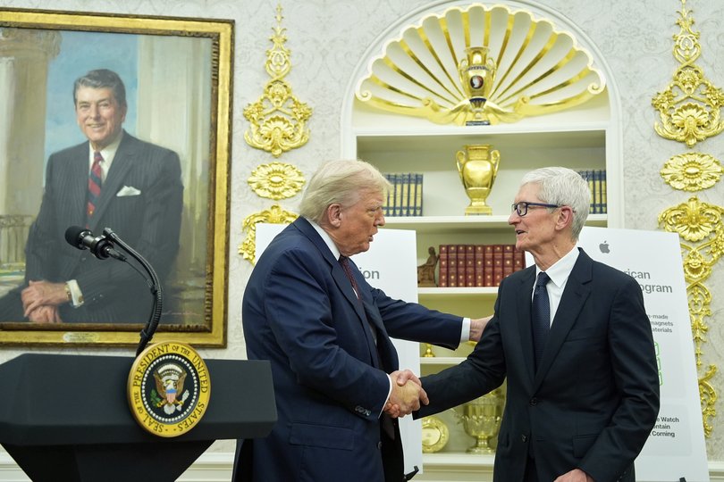 President Donald Trump shakes hands with Apple CEO Tim Cook in the Oval Office.