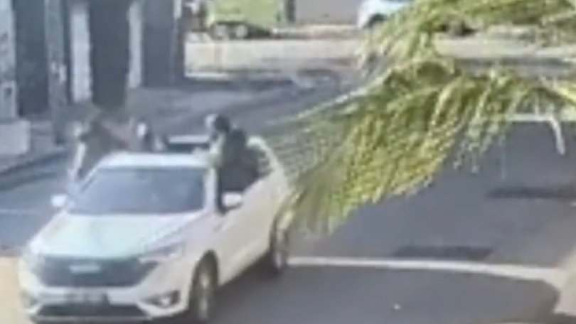 Footage has emerged from Port Melbourne showing a group of masked youths hanging out of a car hunting down two males. Source: 3AW
