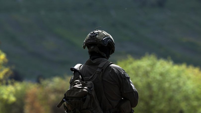 The army says an Israeli soldier damaged a crucifix while another soldier photographed the act. 