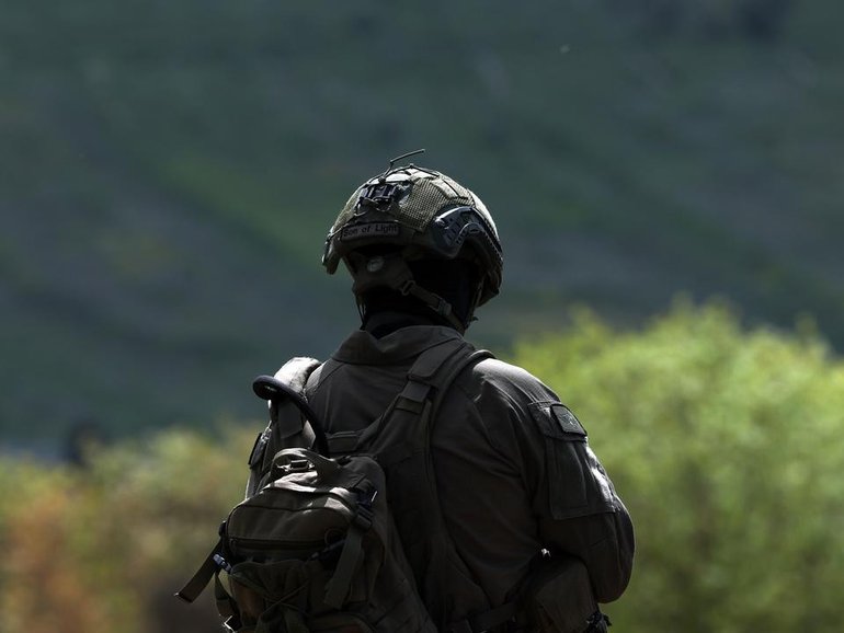 The army says an Israeli soldier damaged a crucifix while another soldier photographed the act. 