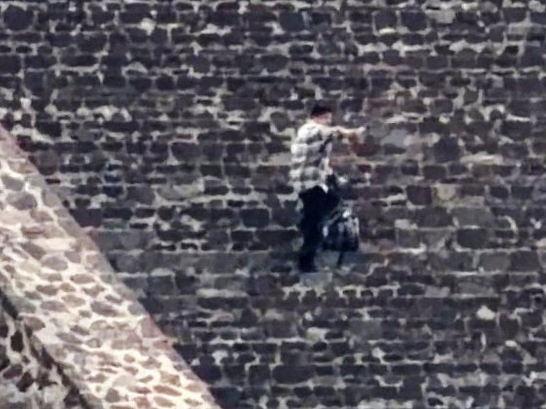 Julio Cesar Jasso Ramirez  fires a weapon  at the Teotihuacan pyramids, a popular tourist and archaeological site in San Martin de las Piramides, on the outskirts of Mexico City.