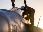 An air force pilot climbs aboard a jet in the Middle East. 