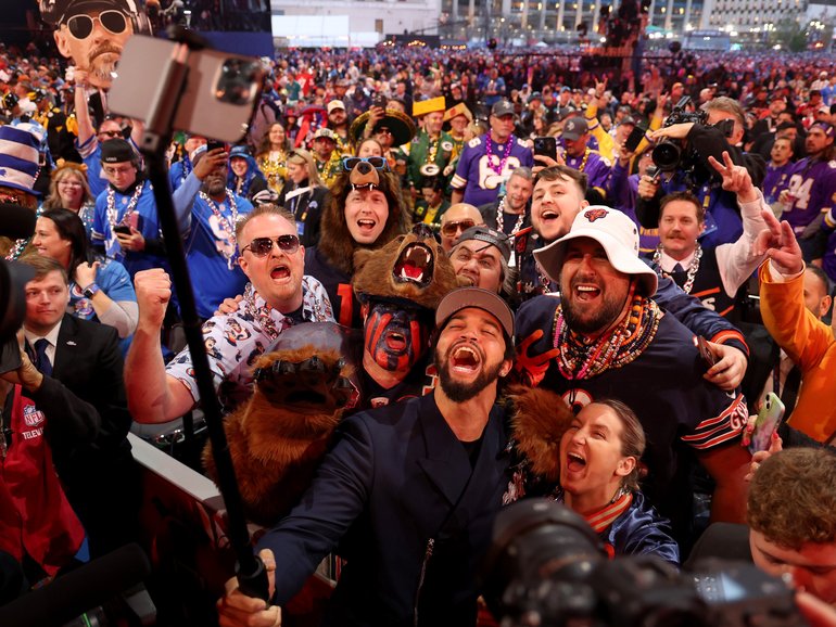 Caleb Williams celebrates with fans after being selected first overall by the Chicago Bears in 2024. 