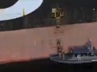 Stills from video posted to X of the seizure of a container ships in the Strait of Hormuz by IRGC Navy fighters.