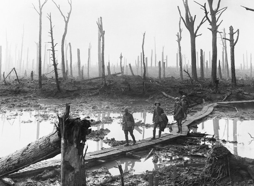 Australian troops walk along duckboards through the remains of Chateau Wood, Third Battle of Ypres (Passchendaele), 29 October 1917.