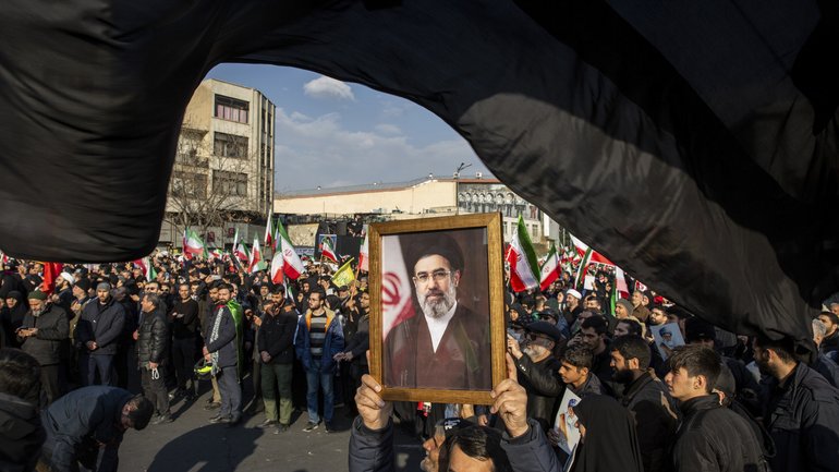 A portrait of Mojtaba Khamenei, the son of the recently killed supreme leader Ayatollah Ali Khamenei, as a crowd celebrates his appointment as his fathers successor at Enghelab Square in Tehran, Iran, on Monday, March 9, 2026. 