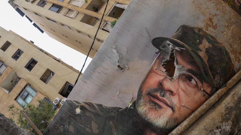 A portrait of a Hezbollah fighter is seen damaged amidst the rubble of a building damaged by an Israeli air-strike in Beirut.