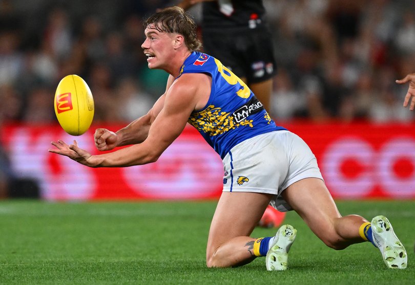 Harley Reid of the Eagles handballs.