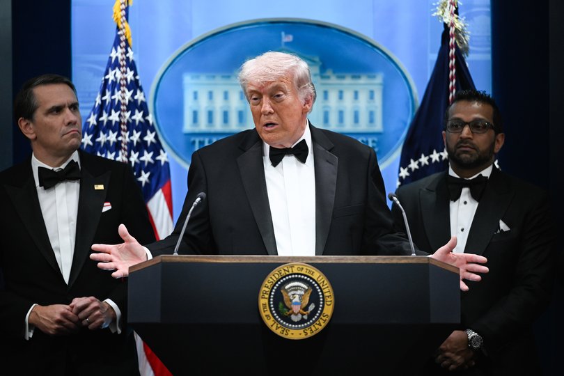 Donald Trump addressing the press still in tuxedo.