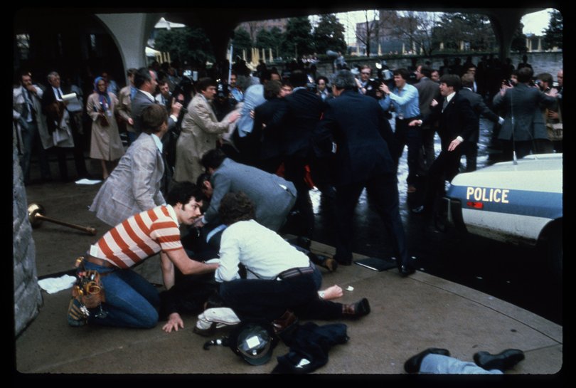 Chaos surrounds shooting victims immediately after the assassination attempt on President Reagan, March 30, 1981, by John Hinkley Jr. outside the Hilton Hotel in Washington, DC. 