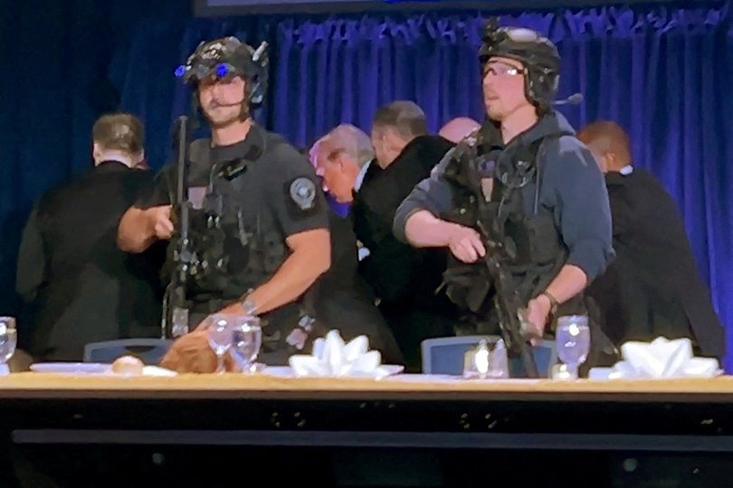 US President Donald Trump is escorted out after a man opened fire with a shotgun.