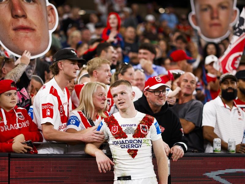 Kade Reed was consoled by proud family and friends after he debuted in the Dragons' huge loss.  (Mark Evans/AAP PHOTOS)