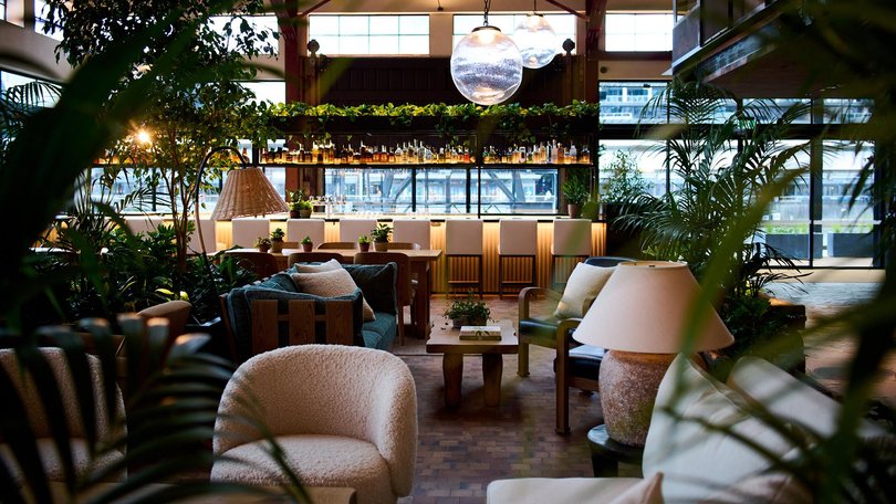 Bell boys in designer denim welcome guests to an expansive lobby framed by original trusses and bluestone pavers from the 1894 building.