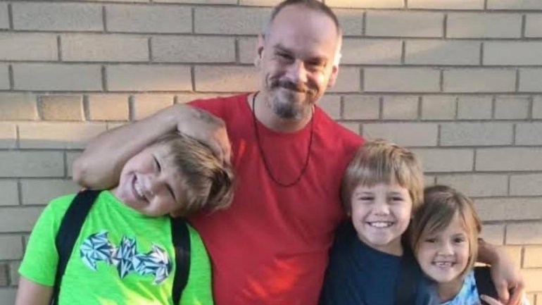 A father has been charged with child neglect after his three young children died in a devastating house fire while he allegedly escaped the burning home.
