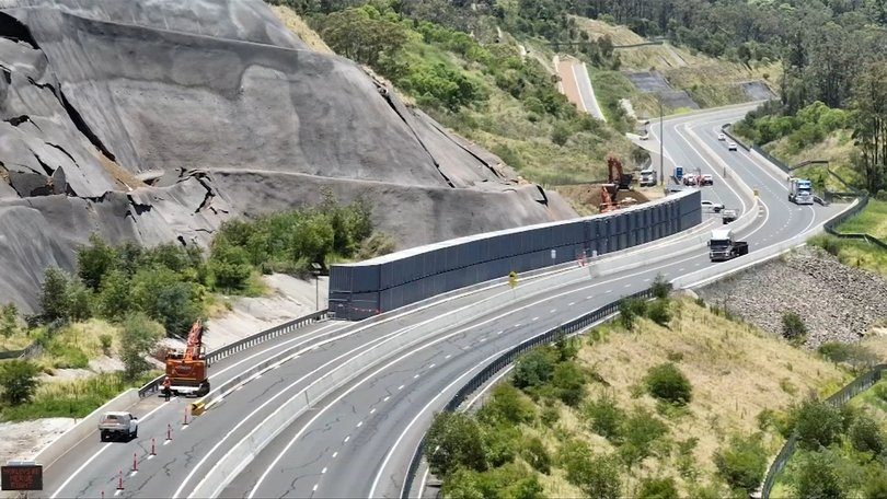 A major road has been closed after two trucks crashed and caught fire near Toowoomba.