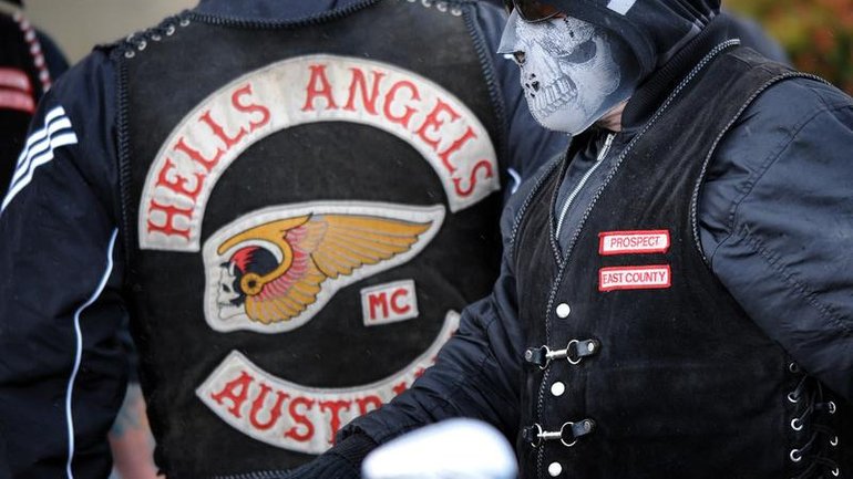 A Hells Angels bikie has been charged after allegedly impersonating a former ADF soldier. 