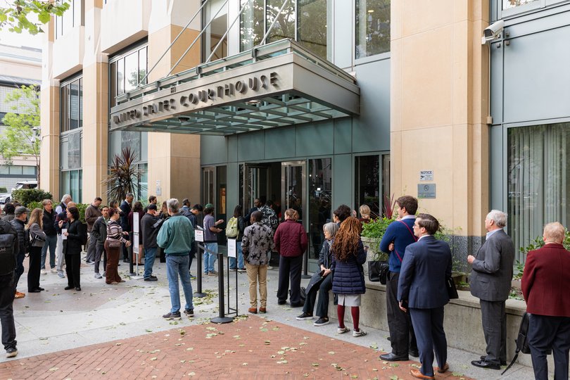 People queue outside The Ronald V Dellums Federal Building and US Courthouse in Oakland where the trial is taking place.