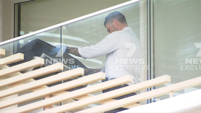 Police inspect a barbecue on the apartment balcony as part of the search operation.