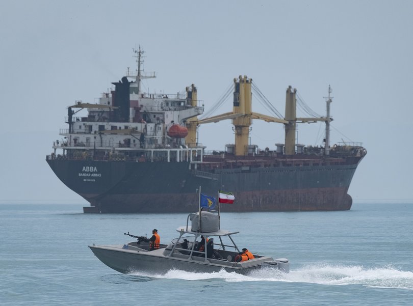 An Islamic Revolutionary Guard Corps (IRGC) speed boat near a general cargo vessel.