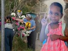 Alice Springs residents place flowers on the gates at the Old Timers Camp before joining a procession to the home of five-year-old Kumanjayi Little Baby.