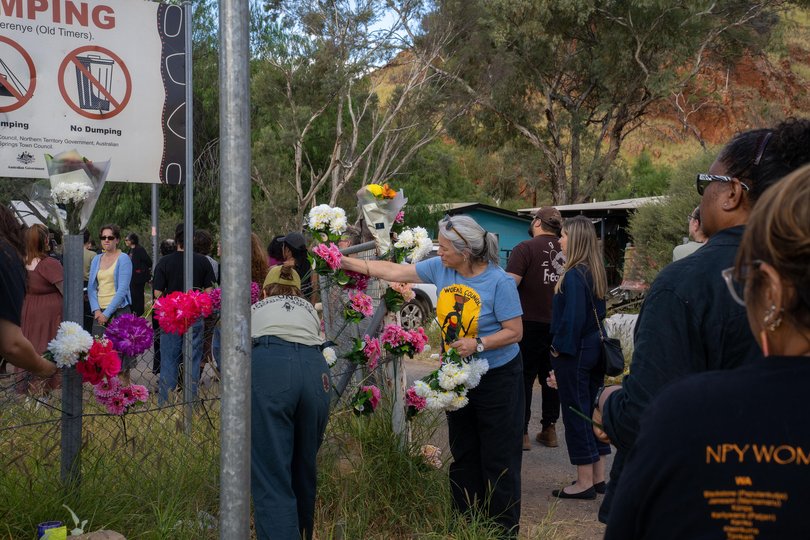 Alice Springs residents place flowers on the gates and fences surrounding the Old Timers Camp.