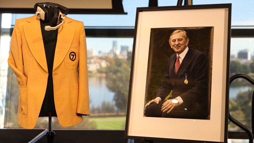Dennis Cometti’s jacket, headset and portrait at Monday’s State memorial service.