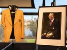 Dennis Cometti’s jacket, headset and portrait at Monday’s State memorial service.