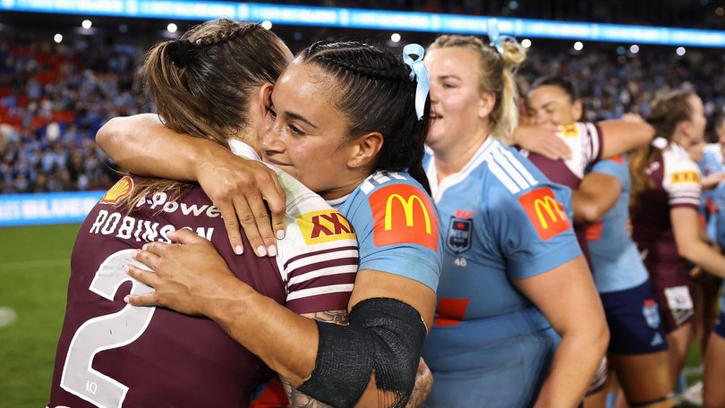 Julia Robinson of the Maroons and Yasmin Meakes of the Blues embrace following game one of the Women's State of Origin series.